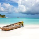 Flick International Abandoned fishing boat on the beach of Turks and Caicos with turquoise waters