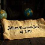 Flick International A weathered parchment scroll displaying the 'Alien Enemies Act of 1798' on a rustic wooden table