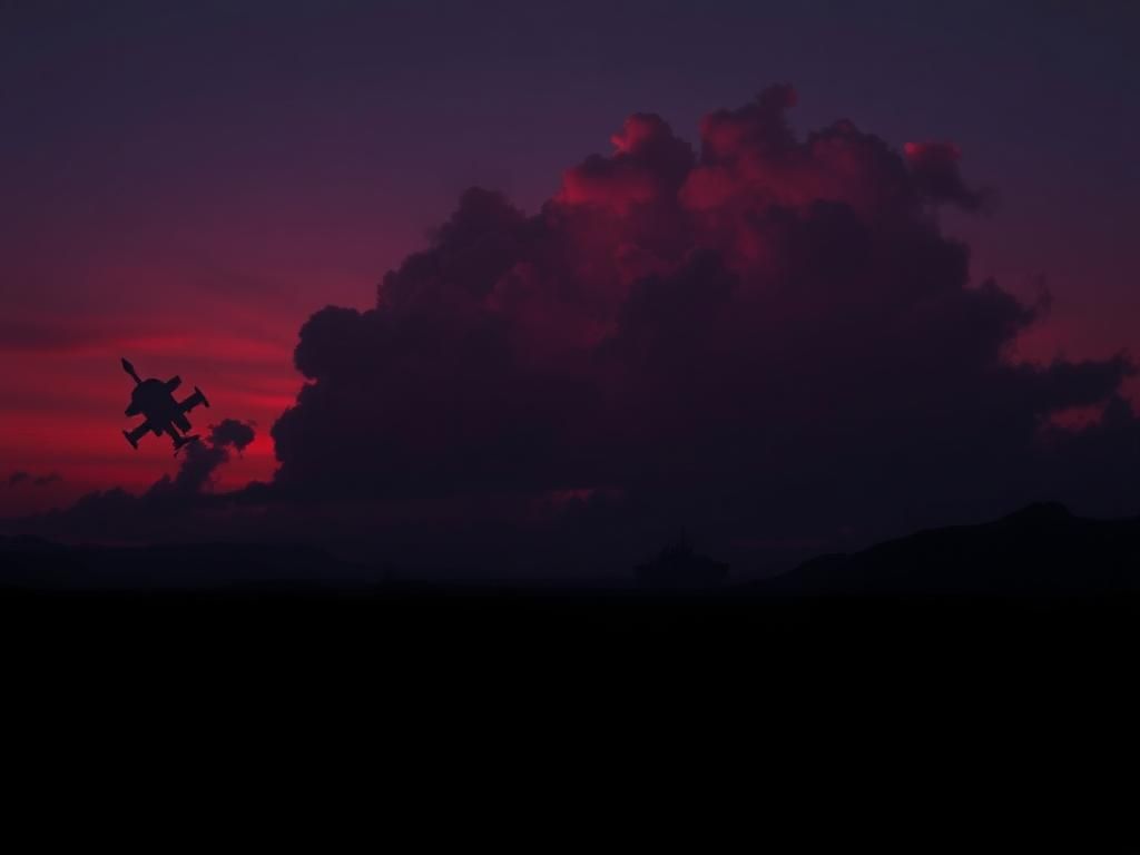 Flick International A dramatic silhouette of rugged Middle Eastern terrain at dusk with ominous clouds gathering