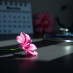 Flick International Close-up of a blooming pink breast cancer awareness ribbon flower on a black surface