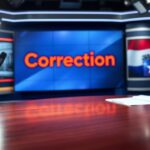 Flick International News studio setting with a large illuminated screen displaying the word 'Correction' in bold red letters