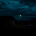 Flick International Dark exterior of the Denver Contract Detention Facility under a cloudy night sky