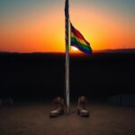 Flick International Military base at dawn with American and pride flags waving in the breeze