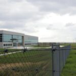 Flick International Close-up view of a modern immigration detention facility in rural Georgia, showcasing its transparency and security features.