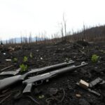 Flick International Aftermath of the Palisades Fire displaying damaged firearms amidst charred terrain