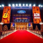 Flick International A vibrant scene of the Ford Center at The Star in Frisco, Texas, decorated for the 2025 ACM Awards