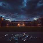 Flick International College campus scene at dusk with broken glass and darkened buildings
