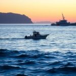 Flick International Dawn scene with a cabin-style boat off the coast of San Diego