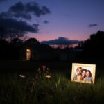Flick International Empty rural home at dusk with family photograph and neglected garden