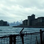 Flick International Panoramic view of Rikers Island jail complex under a moody, overcast sky
