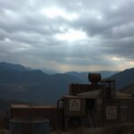 Flick International Abandoned nuclear facility in Iran's mountainous terrain under an overcast sky