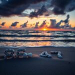 Flick International Beach scene at sunset featuring seashells arranged as '86 47'
