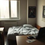 Flick International A minimalist urban scene depicting a modest apartment illustrating financial struggles