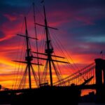 Flick International Mexican Navy tall ship Cuauhtémoc with damaged masts against twilight sky