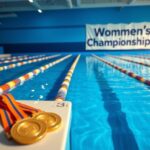 Flick International A serene swimming pool scene with colorful lane dividers and gold medals, capturing the essence of competition in women's swimming.