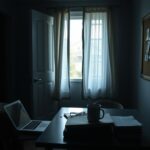 Flick International Dimly lit interior of a college house with abandoned student belongings