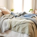 Flick International Serene bedroom scene featuring a beautifully made bed layered with various textured weighted blankets in calming colors.