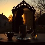 Flick International Shadowy silhouette of a quaint suburban home at sunset, symbolizing secrecy and dual lives of modern Mormon women