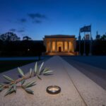 Flick International Dusk scene at the Capital Jewish Museum with intertwined olive branches and a broken engagement ring