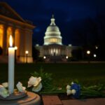 Flick International Somber exterior of the Capital Jewish Museum with a white candle and floral tributes