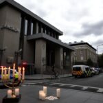Flick International Exterior view of the Capital Jewish Museum highlighting security measures and a menorah vigil