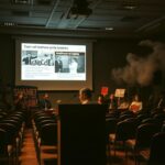 Flick International Hysterical protester interrupts town hall meeting with urgent signs about Gaza
