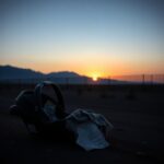 Flick International Abandoned child's car seat with a tattered blanket near the Southern U.S. border at dusk