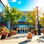 Flick International A sunny street scene in Nashville with a focus on a stylish Nordstrom store and blooming flowers.