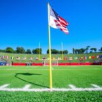 Flick International A dynamic flag football game scene showcasing vibrant green turf and a raised flag symbolizing competition.
