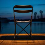 Flick International Sturdy metal folding chair on a wooden dock at twilight representing resilience
