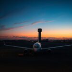Flick International Abandoned airline aircraft surrounded by caution tape on an airport tarmac at twilight