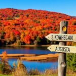 Flick International Vibrant autumn landscape in Maine with colorful fall foliage and a rustic signpost
