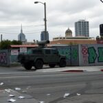 Flick International National Guard vehicle stationed at a Los Angeles street corner amidst anti-ICE protests