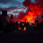 Flick International Chaotic protest scene with silhouettes of protest signs and flames