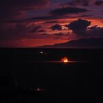 Flick International Dramatic night scene over barren landscape post-airstrikes