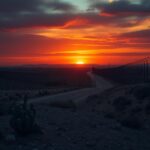 Flick International Desert landscape at the U.S. southern border with barbed wire fencing and dramatic sunset
