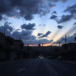 Flick International Desolate cityscape at dusk in Jerusalem, reflecting tension and chaos amidst conflict.