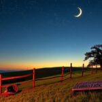 Flick International Idyllic American landscape at dusk with a twinkling starry sky and crescent moon