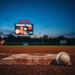 Flick International Baseball diamond at dusk with focus on second base and a baseball lying nearby