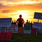 Flick International Peaceful protest scene in Florida with colorful signs for First Amendment rights.
