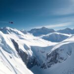 Flick International Steep snow-covered slope leading to rocky precipice in Colorado mountain range