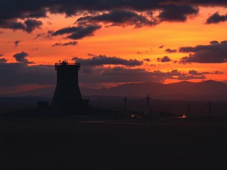 Flick International Dramatic Iranian desert landscape at twilight with nuclear facility silhouettes