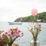 Flick International Serene coastal scene with a small boat decorated for a birthday celebration
