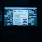 Flick International Close-up of a computer screen showing a suspicious login alert email with red flags