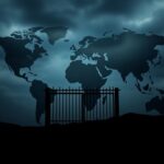 Flick International Dramatic landscape featuring silhouettes of country outlines affected by Trump's travel ban